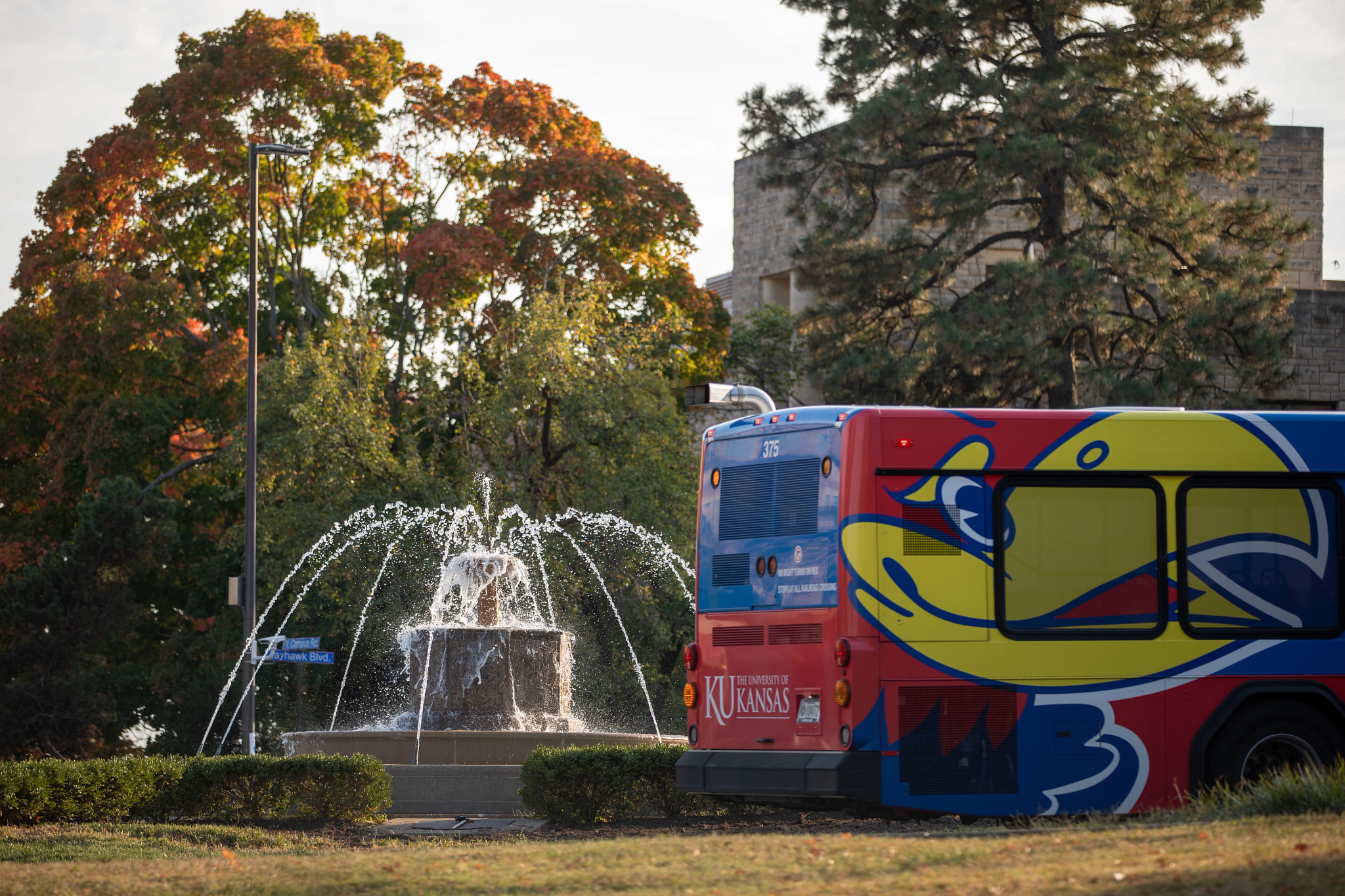 KU bus in front of Chi Omega fountain on Jayhawk Boulevard